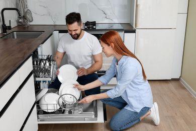 Couple using dishwasher