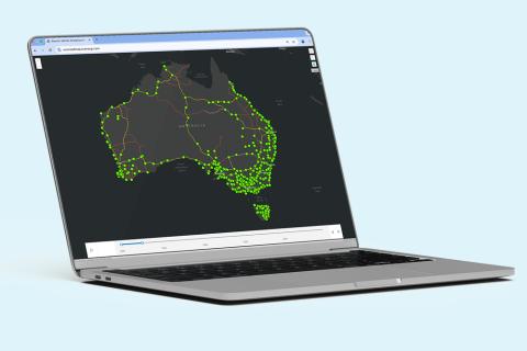 An open laptop displaying a map of Australia with electric vehicle charge stations.